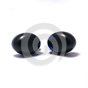 A pair of truly wireless earbuds on a pure white background with shadows