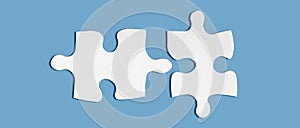 Pair of two matching puzzle pieces isolated on blue background. Successful decision, solution of problem.