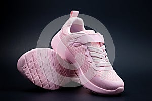 Unbranded pink running shoes on a black background photo