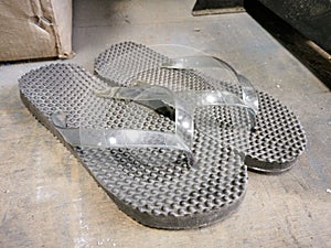 A pair used black slippers.