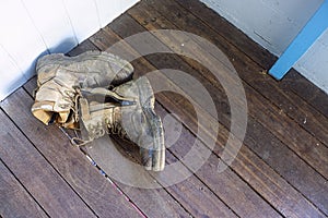 Pair of old work boots left of back porch