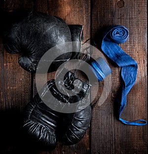 Pair of very old black leather boxing gloves