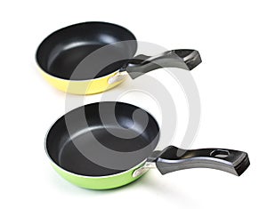 Pair of very small frying pans with non-stick surface, isolated on a white background