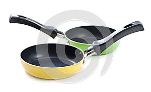 Pair of very small frying pans with non-stick surface, isolated on a white background