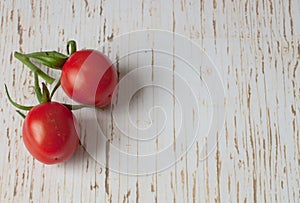 Pair of vine tomatoes on a wooden surface