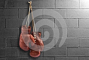 Pair of vintage boxing gloves hanging on a wall