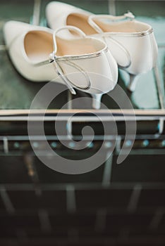 Pair of wedding shoes on green tile photo