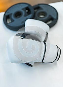 Pair of white boxing gloves. Close up of boxing gloves on table.