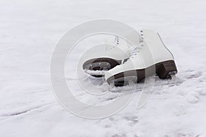 Pair of White Ice Skates in snow