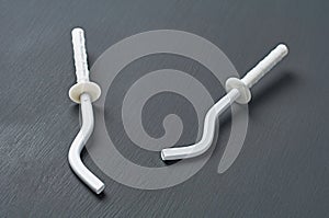 Pair of white new modern hooks for mount aluminum or bimetallic radiator for heating house