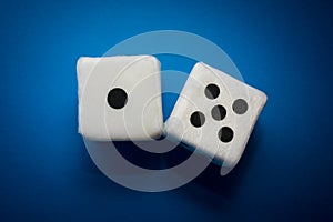 Pair of white plush dices on the blue background