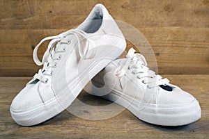 Pair of white sneakers with laces