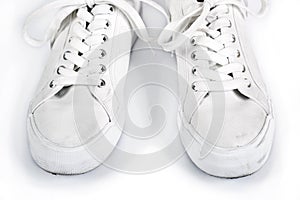 Pair of white sneakers with laces