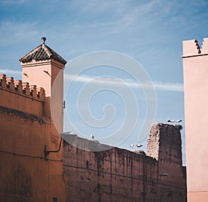 Pair of White Storks on a stick nest and ruined building of Badi palace in the medina of Marrakech Morocco, North Africa