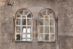 Pair windows with round arches and columns on a concrete background