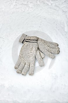 Pair of winter gloves lying in the snow