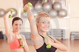 Pair of women doing weights fitness