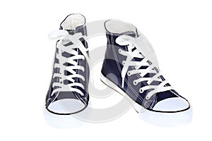 Pair of women`s high top lace up dark navy blue sneakers isolated on white background