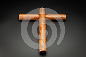 A pair of wooden claves lying on a black underground photo