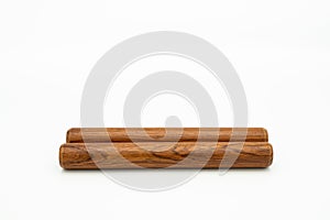 A pair of wooden claves lying on a white underground photo