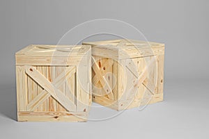 Pair of wooden crates on grey