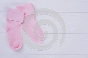 Pair of woolean pink baby socks with copyspace