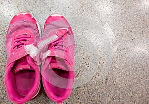 pair of worn out children& x27;s sneakers with scuffs damaged straps.