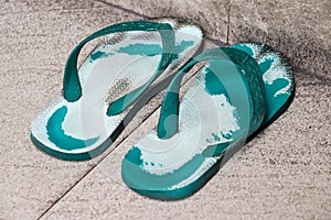 A pair of worn sandals photographed from the right