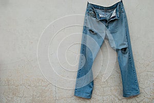 A pair of worn and worn old jeans from time