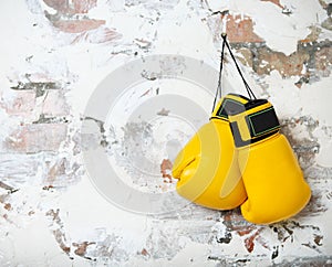 Pair of yellow boxing gloves hanging