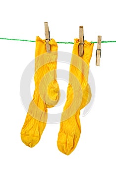Pair of yellow socks hanging on the rope photo