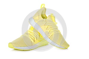 Pair of yellow sport shoes on white background