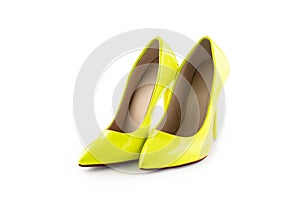 Pair of yellow women`s high-heeled shoes on white background