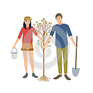 Pair of young cheerful male and female volunteers or ecologist planting tree in park together isolated on white photo