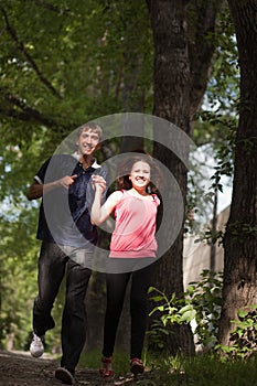 Pair of young lovers running in the park