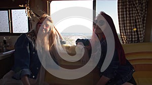 Pair of young women on a sofa in the background of the sea on the highway freighters