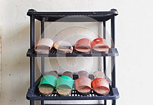 Pairs of home-made traditional wooden shoes on the shoe rack.