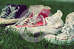 Pairs of sneakers in green grass