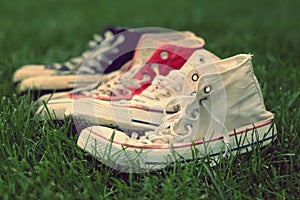 Pairs of sneakers in green grass