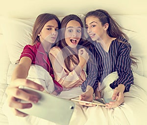 Pajama party best friend girls selfie at bed