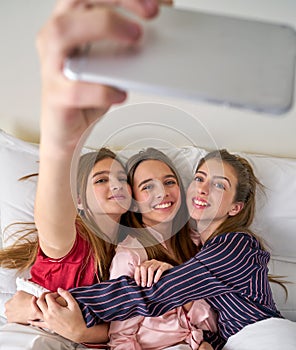 Pajama party best friend girls selfie at bed