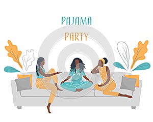 Pajama party. Three young black women in pajamas are sitting on the couch and talking