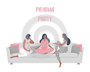 Pajama party. Three young women in pajamas are sitting on the couch and talking