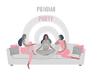 Pajama party. Three young women in pajamas are sitting on the couch and talking