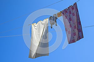 Pajamas and sheets hanging from a thread