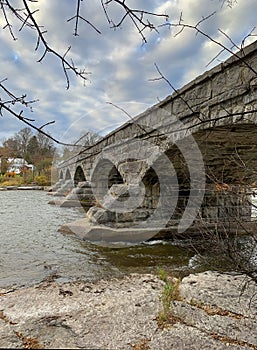 Pakenham Bridge, a five span stone bridge that crosses the Mississippi River on a cloudy autumn day in Pakenham, Canada