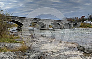 Pakenham Bridge, a five span stone bridge that crosses the Mississippi River on a cloudy autumn day in Pakenham, Canada