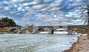 The Pakenham Bridge, a five span stone bridge that crosses the Mississippi River on a cloudy autumn day in Pakenham, Canada