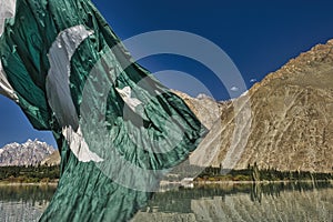 Pakistan falg over Attabad lake in autumn season at northern Pakistan