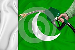 PAKISTAN flag Close-up shot on waving background texture with Fuel pump nozzle in hand. The concept of design solutions. 3d